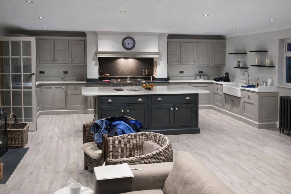 Bespoke in-frame shaker kitchen with custom island and farmhouse sink.