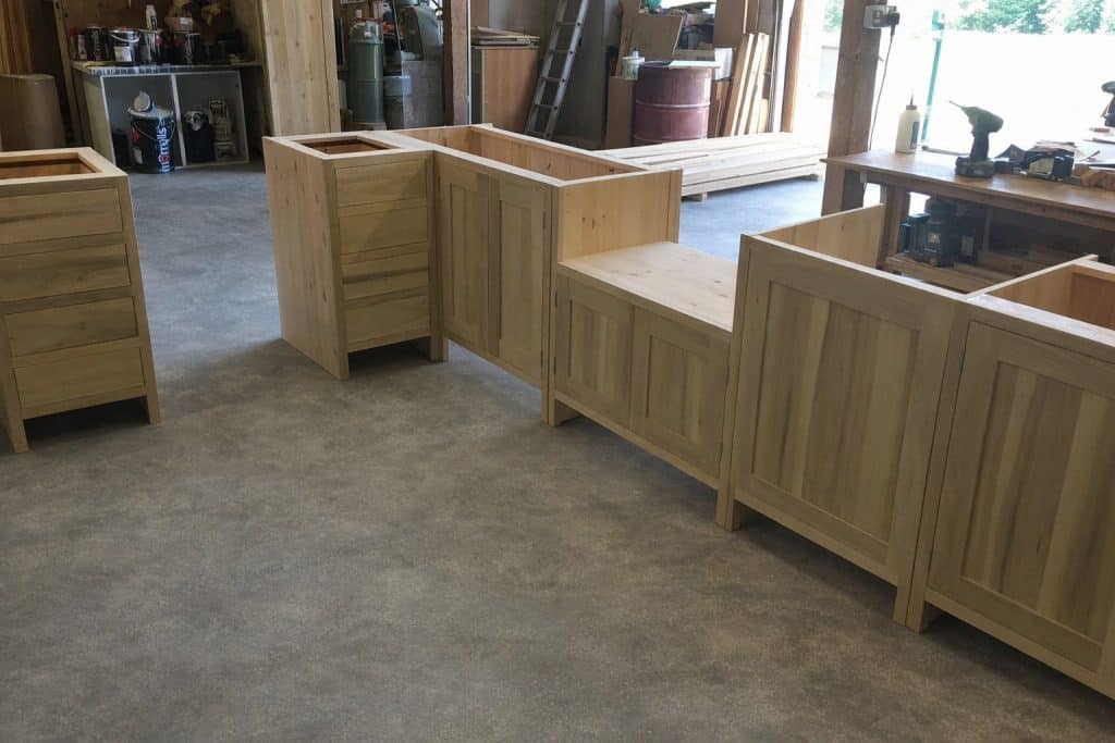Bespoke kitchen units prepared for spraying, with tulip-style doors and frames on pine carcasses in the workshop