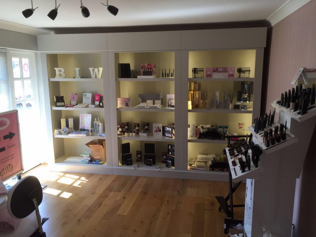 Bespoke shopfitted display units with illuminated shelving in a beauty salon in Great Dunmow, Essex