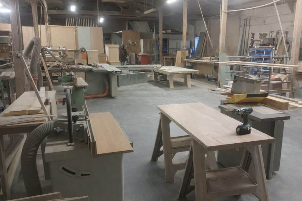 Joinery workshop showing woodworking machinery and production area during furniture manufacture