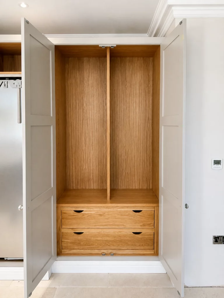 Grey in-frame kitchen installation with oak interiors and white quartz worktops in Braintree, open pocket-style cabinet with oak drawers.