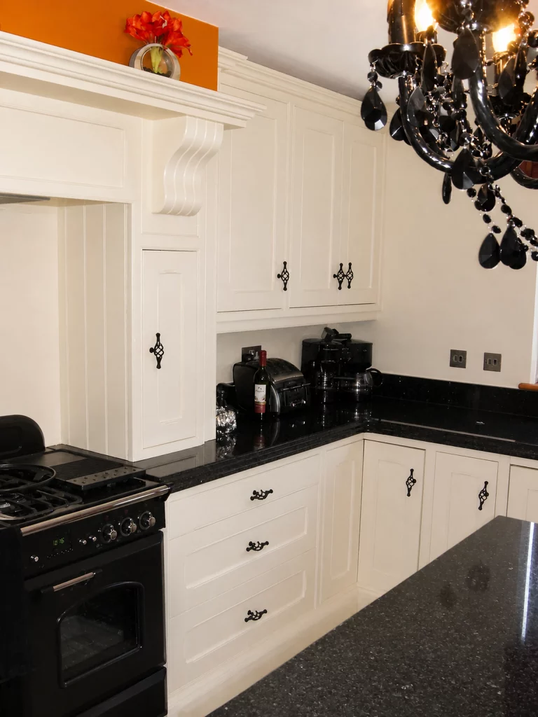 White painted Shaker kitchen with Star Galaxy granite and a central island in Wickham Bishops, corner cabinetry and granite preparation area.